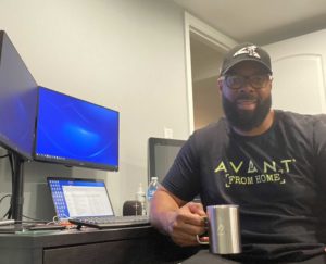 Anthony at his desk wearing Avant swag
