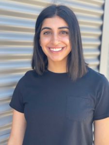 Smiling Jaitika in a black shirt