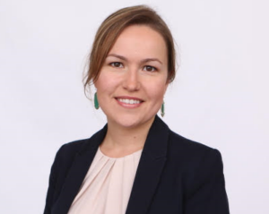 Tatyana, Senior Manager of FP&A, smiling in a suit jacket and white blouse