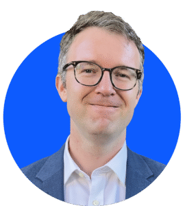 Nick smiling on a blue background