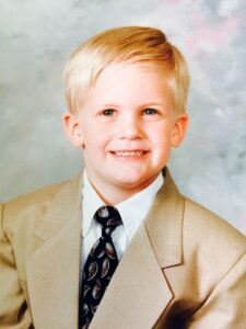 Baby Charles, smiling in a suit