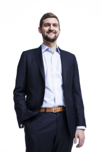 Charles smiling in a suit