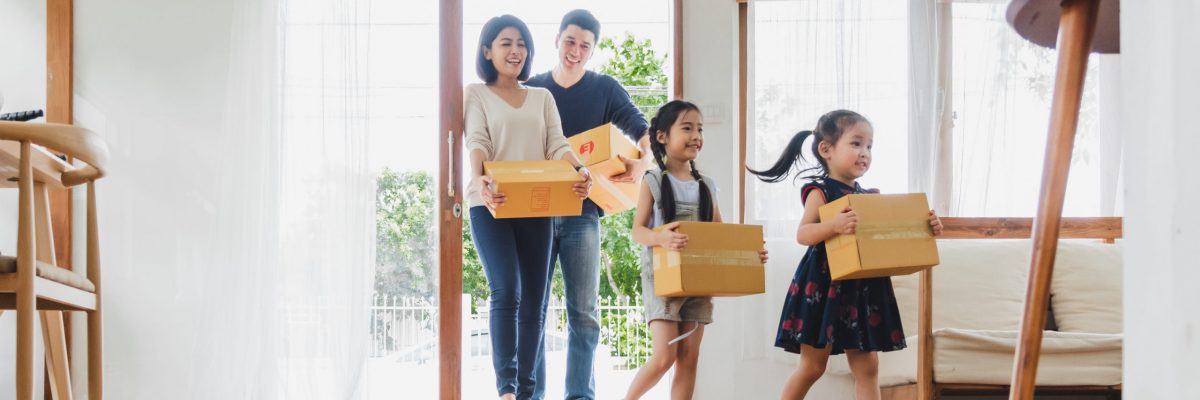 Asian family moving to new home / apartment with many packing boxes